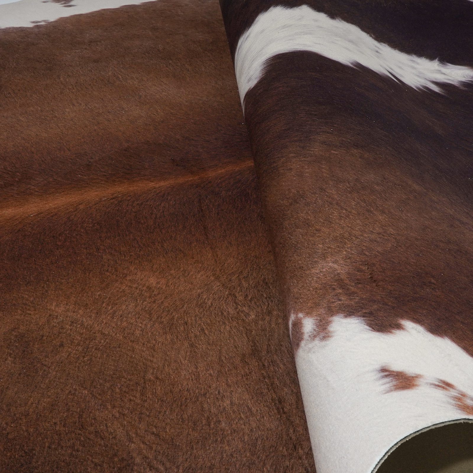 Faux cowhide rug material swatches close-up