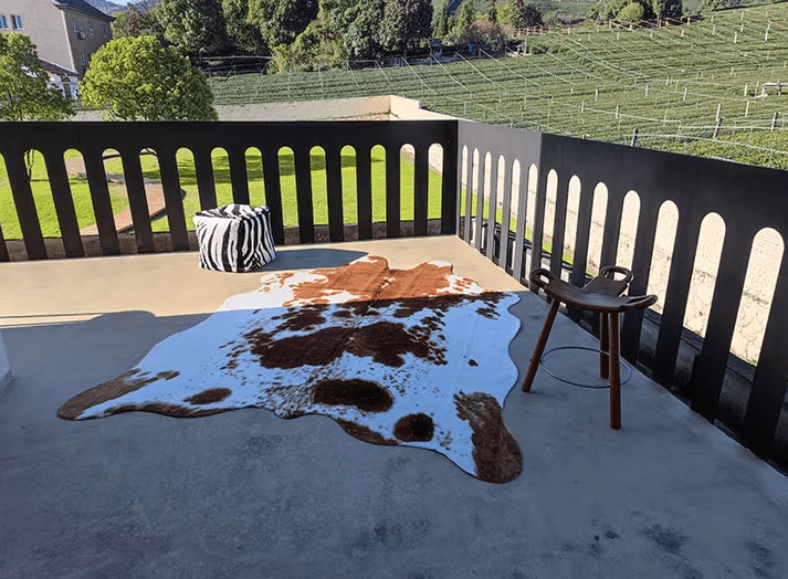 Faux cowhide rug on a cozy sunset balcony