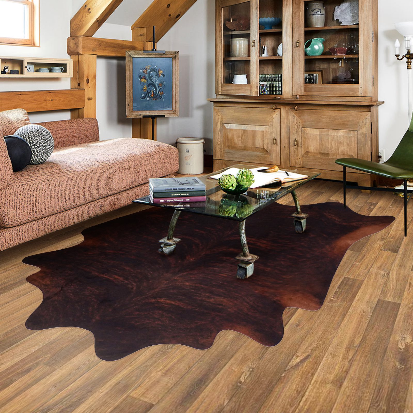 Faux cowhide rug placed under a mid-century modern coffee table in a living room