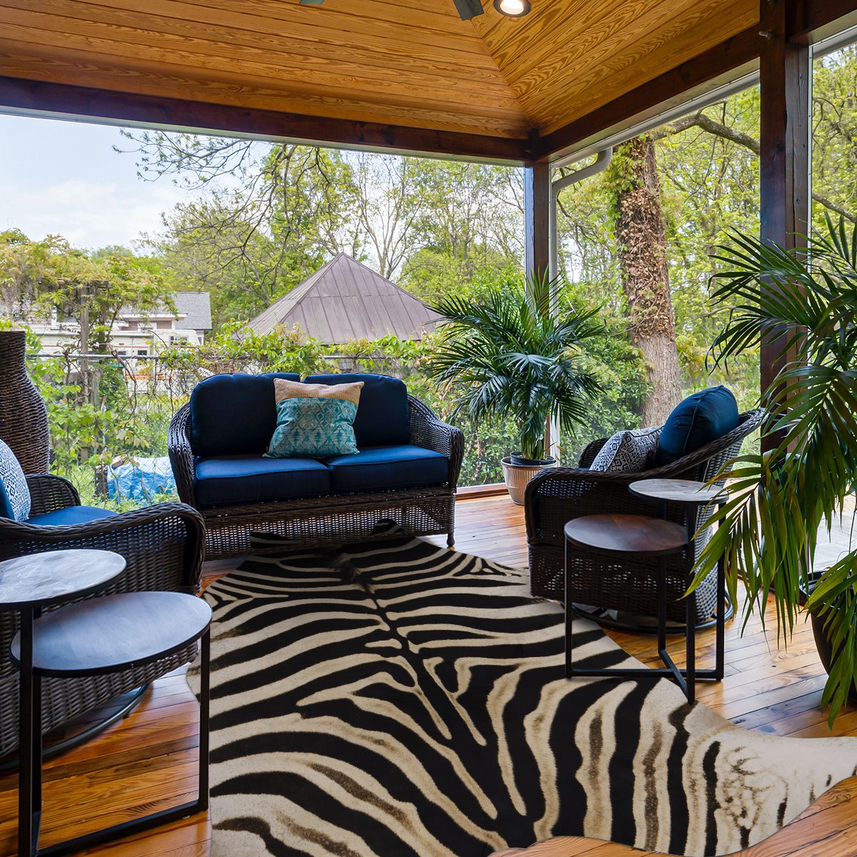  Zebra-patterned faux cowhide rug with metal patio chairs