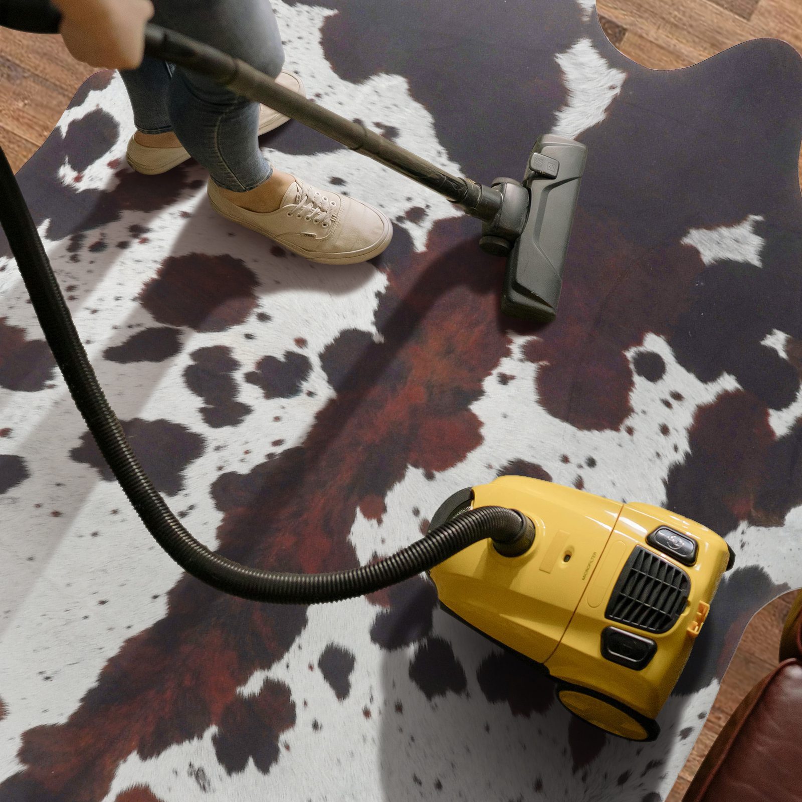 Vacuuming a faux cowhide rug for routine cleaning