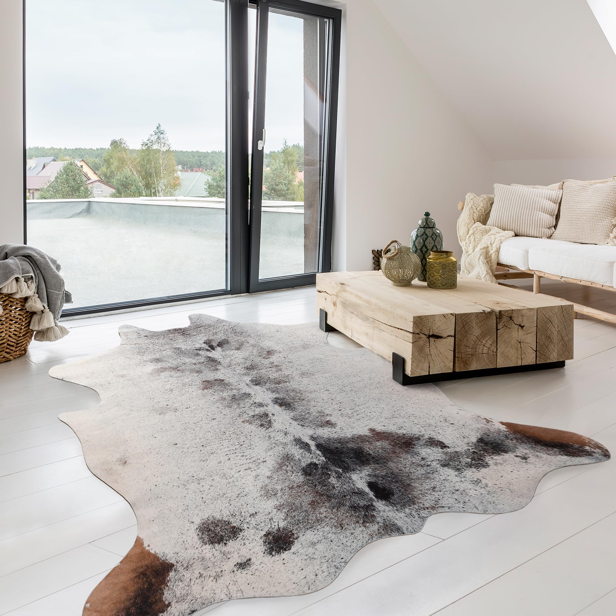 Light-colored cowhide rug complementing cool interior decor