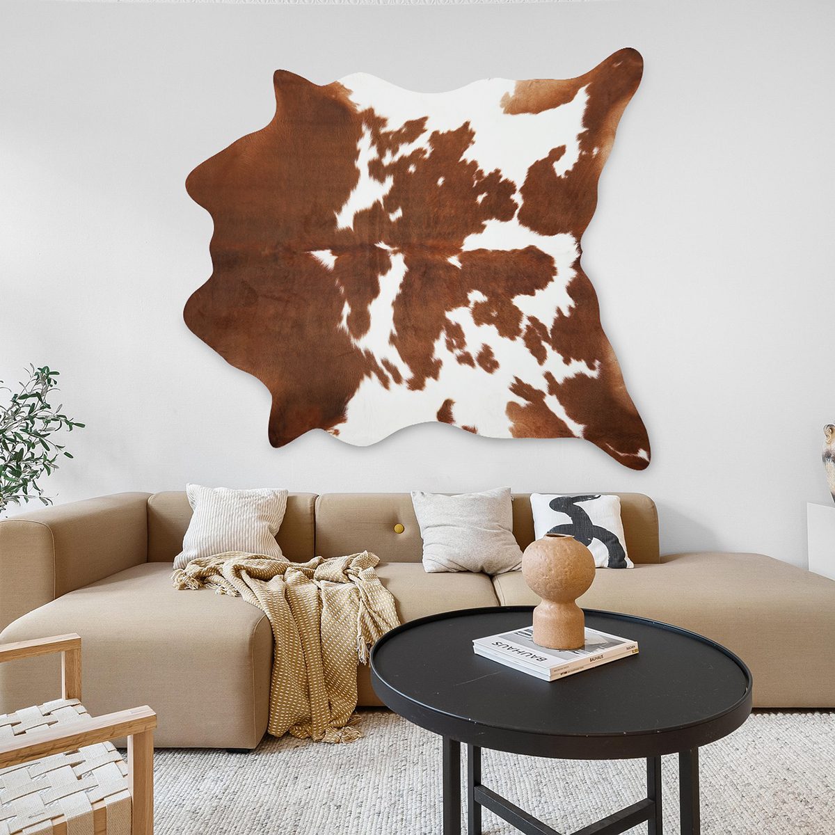 Neutral-toned living room styled with faux cowhide rug and modern furniture